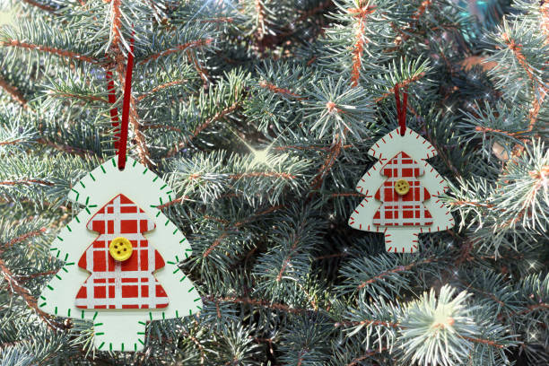 istock Two wooden painted Christmas tree on a blue tree. 1193359452