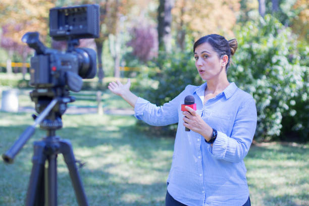istock Woman reporter reporting from field 1193361478