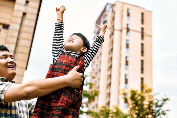 istock chinese father lifting up little daughter 1193361674