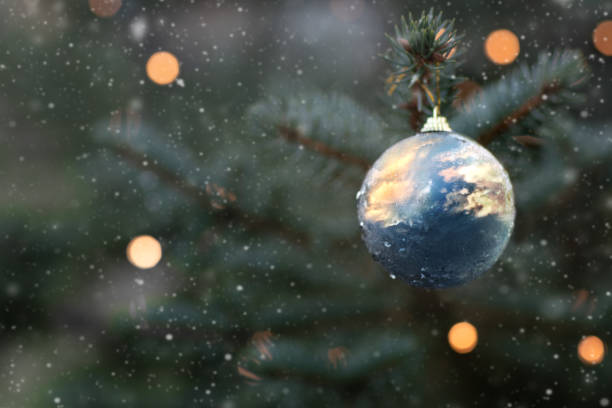 istock Christmas tree toy with reflection of sunset sky. 1193364694