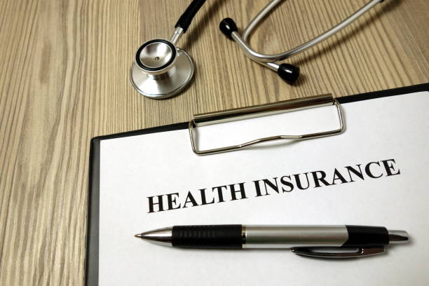 istock Health insurance form with pen and stethoscope 1193365950