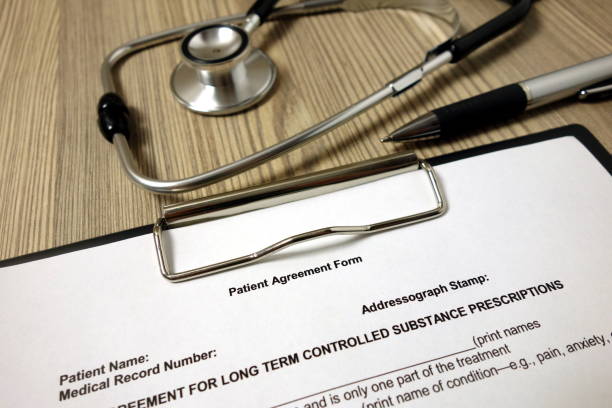istock Patient agreement form with pen and stethoscope 1193366294