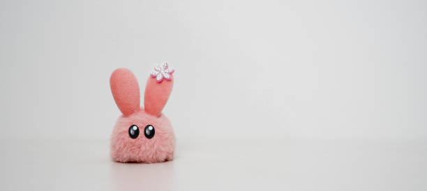 Close up of cute pink rabbit toy isolated on white background