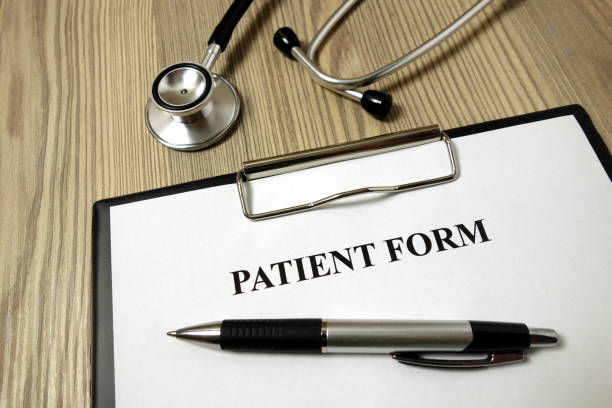 istock Patient form for filling with pen and stethoscope 1193366417