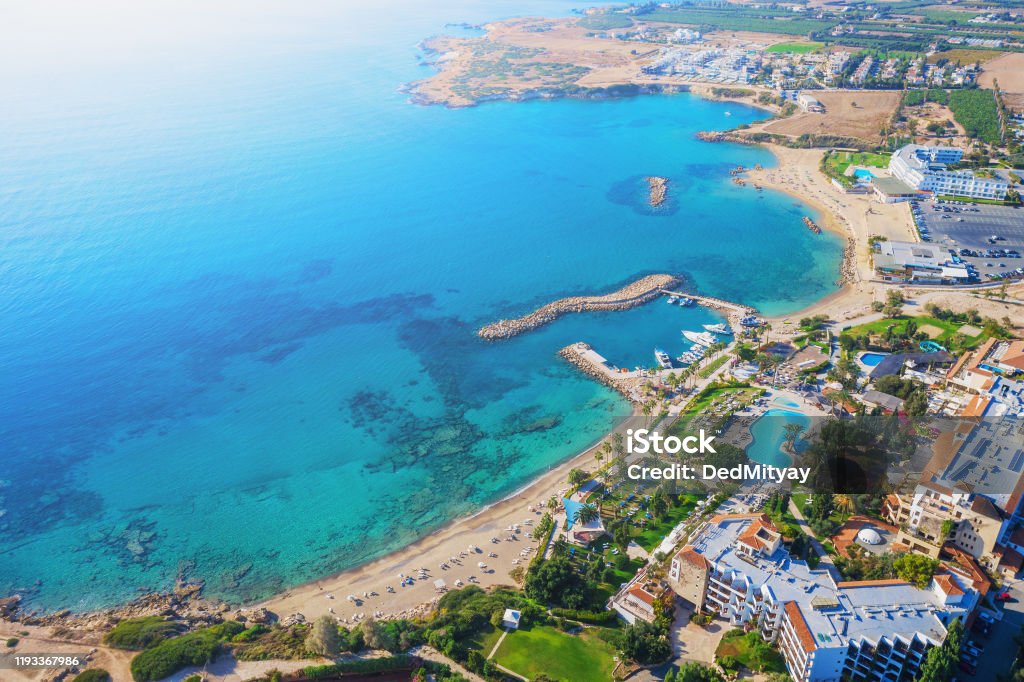 Cyprus landscape. Aerial panoramic view of bay with sandy beach and hotel on coastline, drone photo. Mediterranean vacation and travel concept Cyprus landscape. Aerial panoramic view of bay with sandy beach and hotel on coastline, drone photo. Mediterranean vacation and travel concept. Republic Of Cyprus Stock Photo