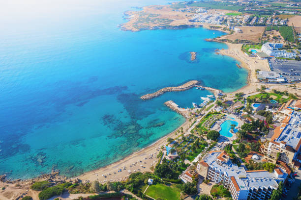 Cyprus landscape. Aerial panoramic view of bay with sandy beach and hotel on coastline, drone photo. Mediterranean vacation and travel concept Cyprus landscape. Aerial panoramic view of bay with sandy beach and hotel on coastline, drone photo. Mediterranean vacation and travel concept. limassol stock pictures, royalty-free photos & images
