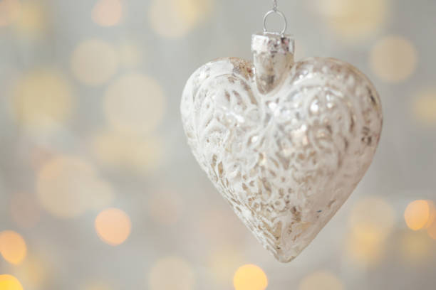 istock christmas card, white heart with soft bokeh background 1193369220