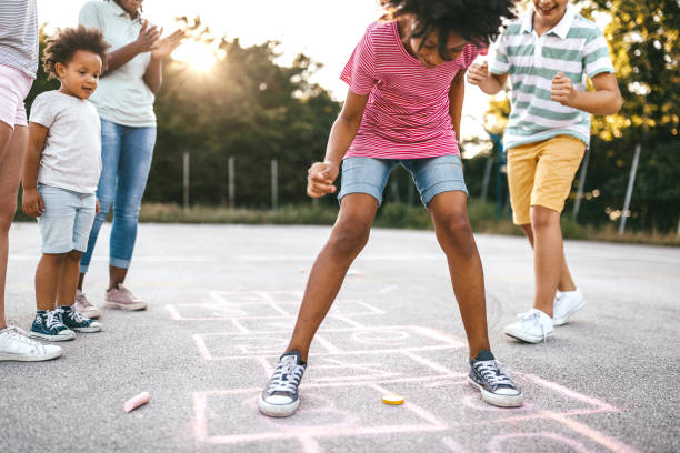 istock Multi-ethnic group of kids playing hopscotch outside 1193370253