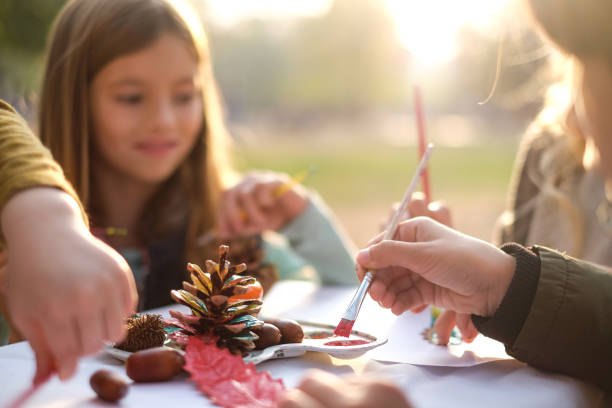 Close up kids coloring pine cones
