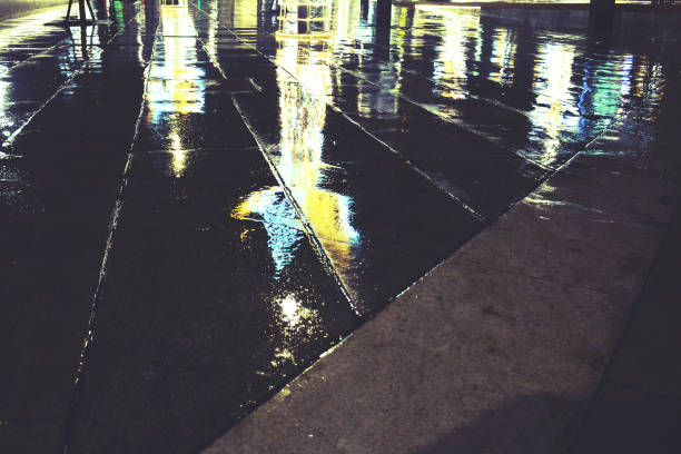 istock Christmas lights with reflection on the street, rainy day. 1193373875