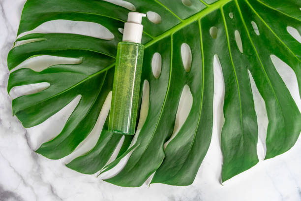 istock bio cosmetic product on leaf with marble background . 1193375281