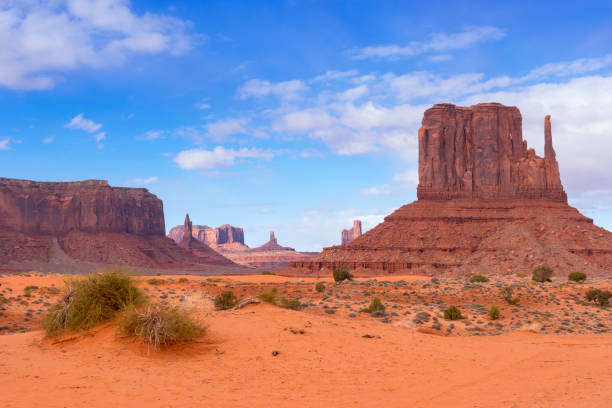 Monument Valley Buttes in Monument Valley, Arizona, under a nicely clouded sky mesa arizona stock pictures, royalty-free photos & images