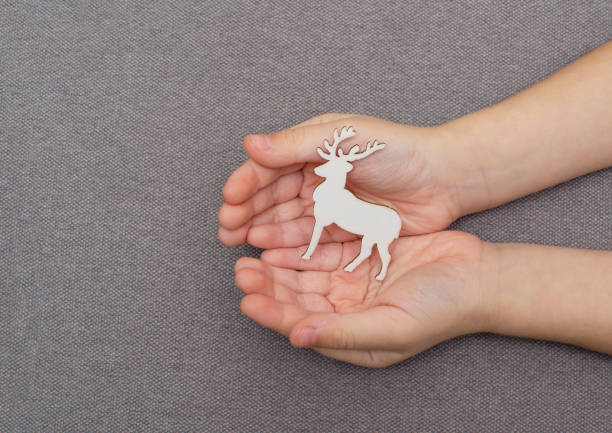 istock figurine of a deer in children's hands 1193376359