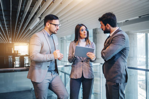 istock Successful group of real estate agents standing in building in construction process and talking about the best way to sell it. Woman in the middle holding tablet. 1193381081