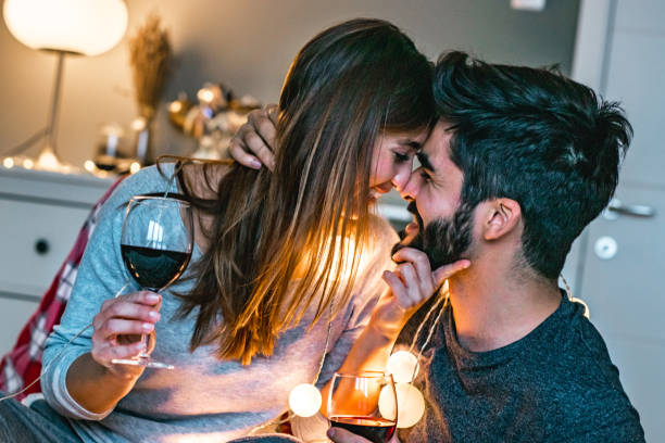 istock Young couple toasting with wine in bed 1193381102