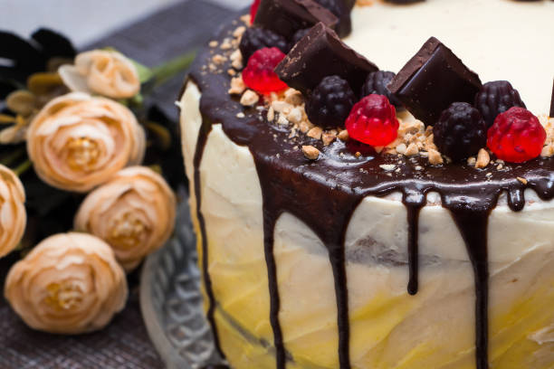 istock Sweet cake with chocolate icing and marmalade on a brown background 1193388084