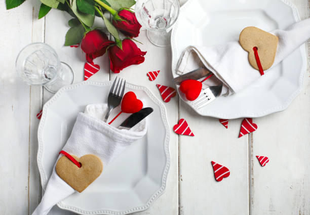 istock Festive table setting for Valentine's Day with cutlery and gift boxes on white wooden table 1193389939