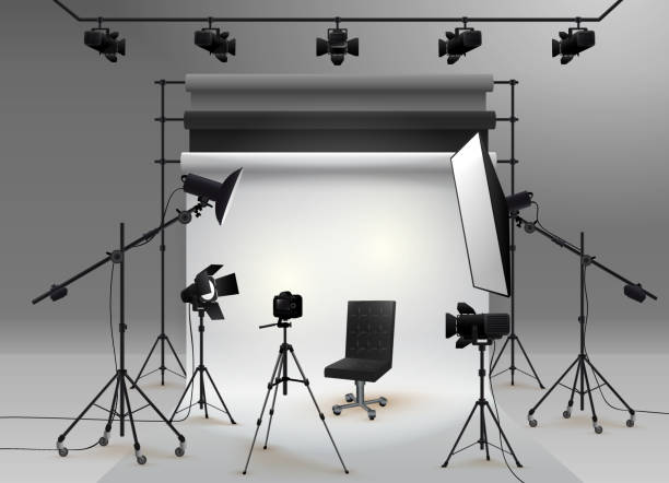 Photography studio vector. Photo studio white blank background with soft box light, camera, tripod, chair and set of backdrop. Vector illustration. Isolated on white background. Photography studio vector. Photo studio white blank background with soft box light, camera, tripod, chair and set of backdrop. Vector illustration. Isolated on white background. spot lit photos stock illustrations
