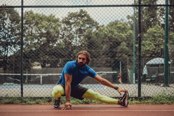 istock Bearded athlete man stretching leg outdoor 1193392397