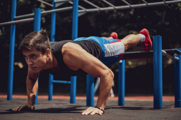 istock Athletic man doing push ups outdoors 1193392404