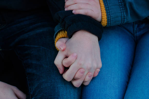 istock Couple holding hands close-up 1193393430