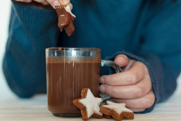 istock Woman hands dipping cookie in hot chocolate 1193394336
