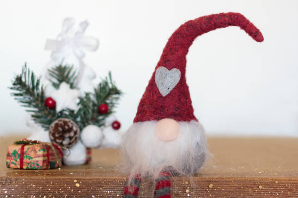 istock Christmas gnome with presents and christmas tree 1193394400