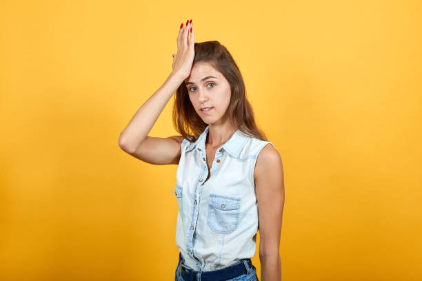 istock Attractive caucasian young woman keeping hand on forehead, looking directly 1193395829