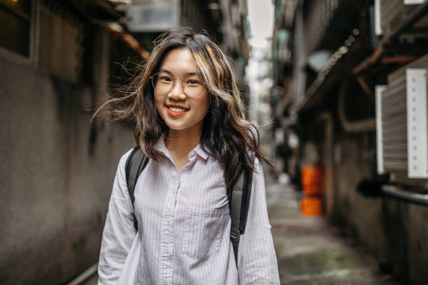 istock Cheerful female student with backpack in the city 1193397389