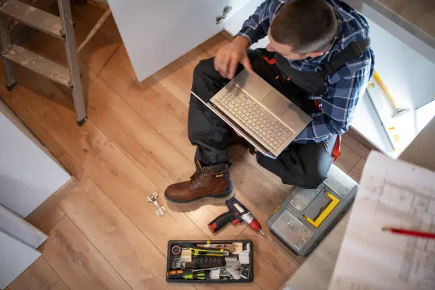 Photo of Manual worker fitting a new kitchen.