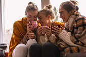 Close-up of happy close female friends sharing cozy time