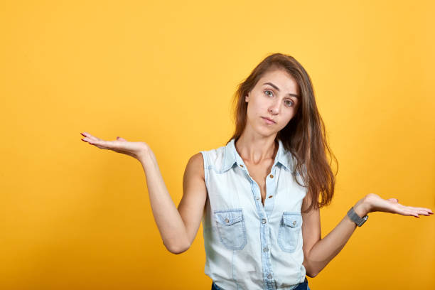 istock Confused caucasian young woman spreads hands 1193401360