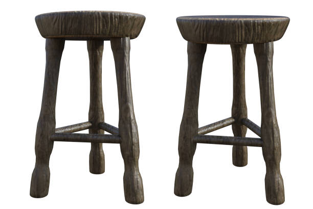A brown wooden stool in front of dark wall