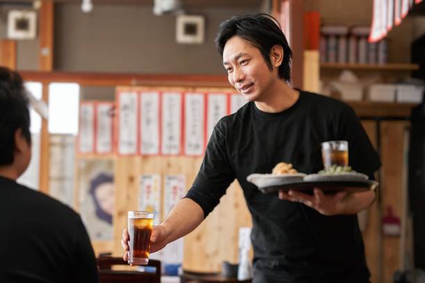 Job image of a man working in a pub Job image of a man in his 30s working at a Japanese restaurant food and drink establishment stock pictures, royalty-free photos & images