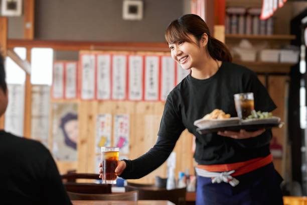 Job image of a woman working in a pub Recruitment image of a woman in her 20s working at a Japanese restaurant food and drink establishment stock pictures, royalty-free photos & images