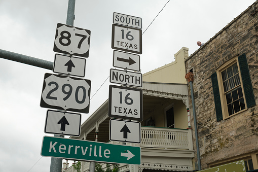 Highway signs along Main Street in Fredericksburg, Texas in the hill country.