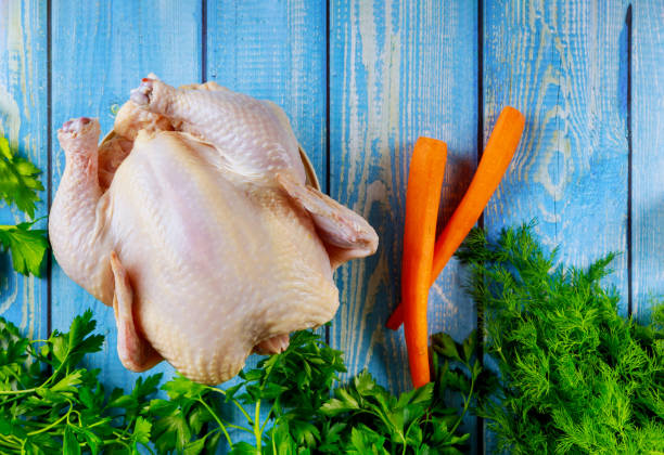 istock Raw whole chicken with vegetable ready for cooking. 1193409329