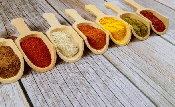 istock Various spices in wooden spoons on a wooden table. 1193409391