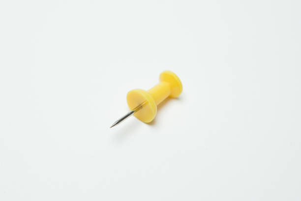 istock Close up of Yellow pin on white background 1193410267