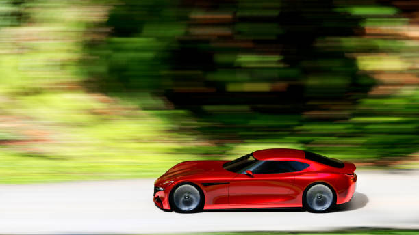 istock red car driving on a forest road 1193410351