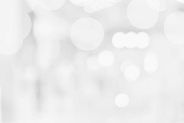 istock White Blurred Abstract bokeh background with circles background Template for a holiday card with bright and sparkling lights. 1193410655