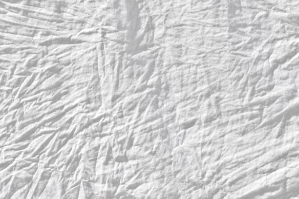 istock Wrinkled white fabic texture cloth texture ,Soft focus white fabic crumpled from bedding sheet use us background 1193410660
