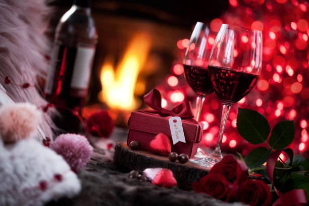 istock Valentine's Day Red Wine in Front of Fireplace with Chocolates 1193416092