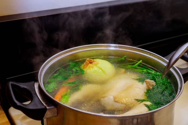 istock Whole chicken soup with vegetables in a pot. 1193425109