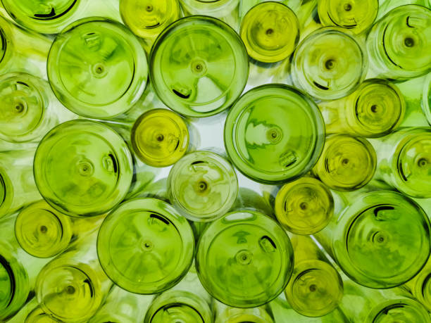 istock Unique, random and artistic display decorative background with various sizes green glass bottles 1193425188