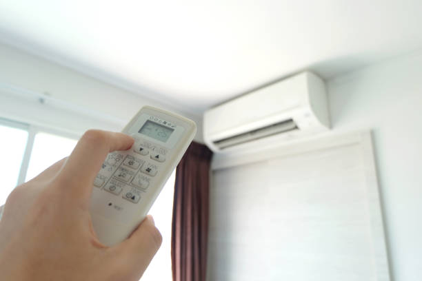 istock Man's hand using remote control open The air conditioner is cooled to 25 degrees Celsius in his bedroom. Health concepts and energy savings 1193425714