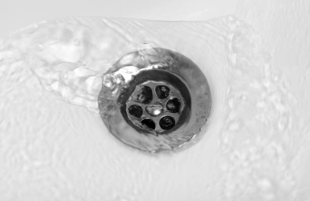 istock Water flows into the middle of a white ceramic sink. Close up 1193425878