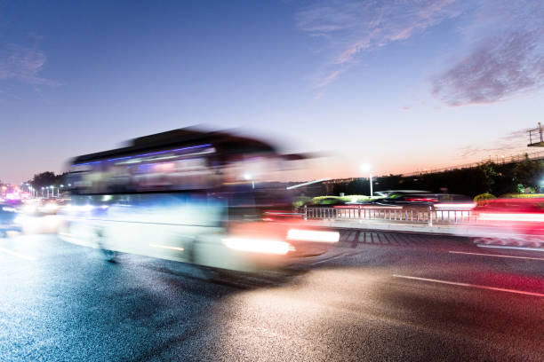 istock Bus driving on highway at dusk 1193427615