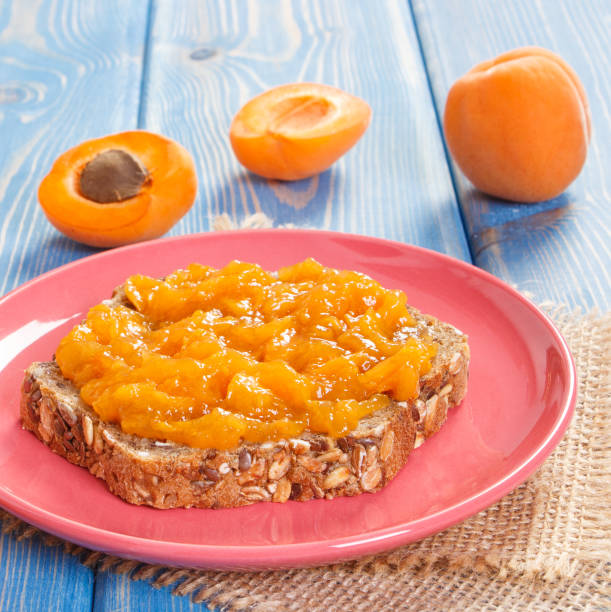 Sandwich with apricot marmalade or jam on plate, sweet dessert concept