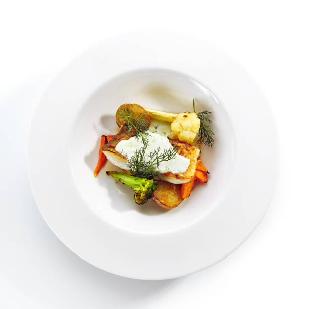 istock Cod Fillet with Baked Vegetables on White Restaurant Plate Isolated 1193429214